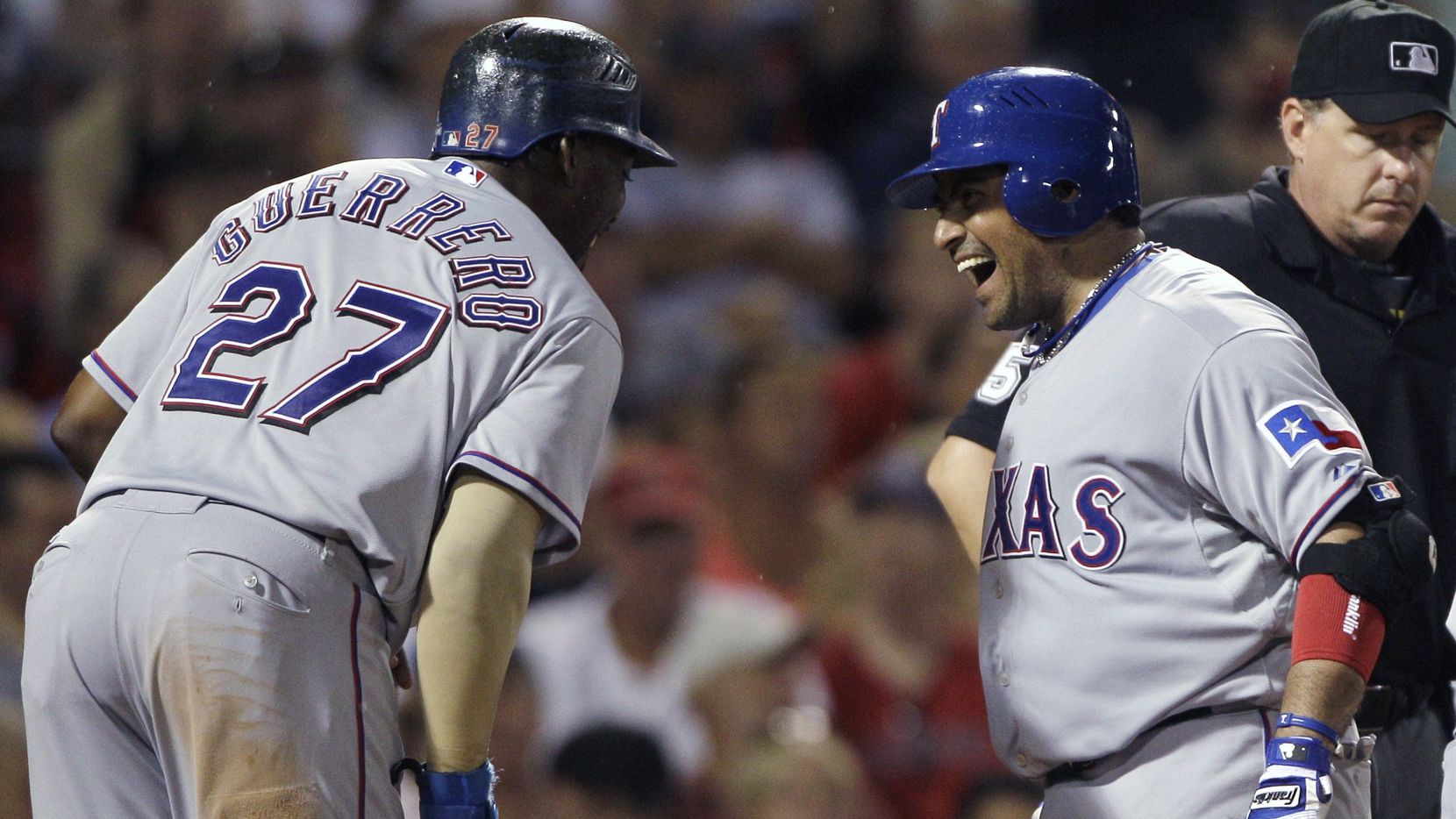 FILE - The Rangers' Bengie Molina, right, laughs with Vladimir Guerrero after crossing home...