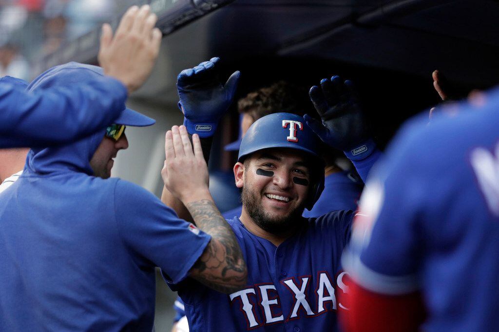 Texas Rangers Jose Trevino celebrates after hitting a solo home run during the fifth inning...