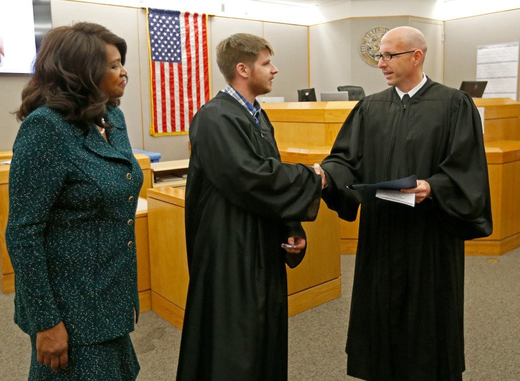 Judge Brandon Birmingham (right) shakes hands with Charles Troutman (center) as Dallas...