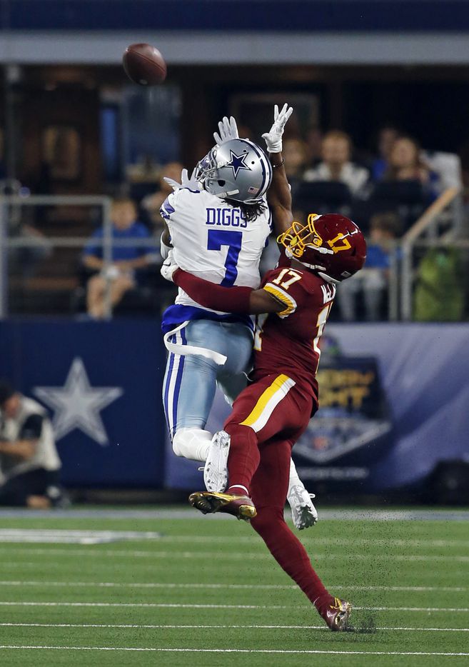 Dallas Cowboys cornerback Trevon Diggs (7) grabs an interception over Washington Football Team wide receiver Terry McLaurin (17), tying an all-time team season interception record of 11 picks, during the first half of a NFL football game against/between the Dallas Cowboys and the Washington Football Team at AT&T Stadium in Arlington, TX on Sunday, December 26, 2021.