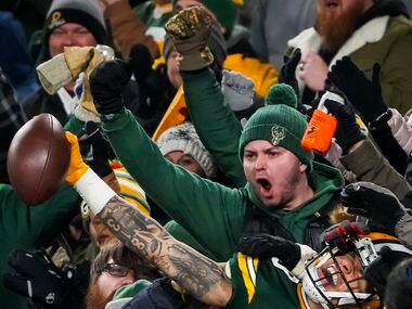 Green Bay Packers wide receiver Christian Watson (9) celebrates with fans after scoring on a...