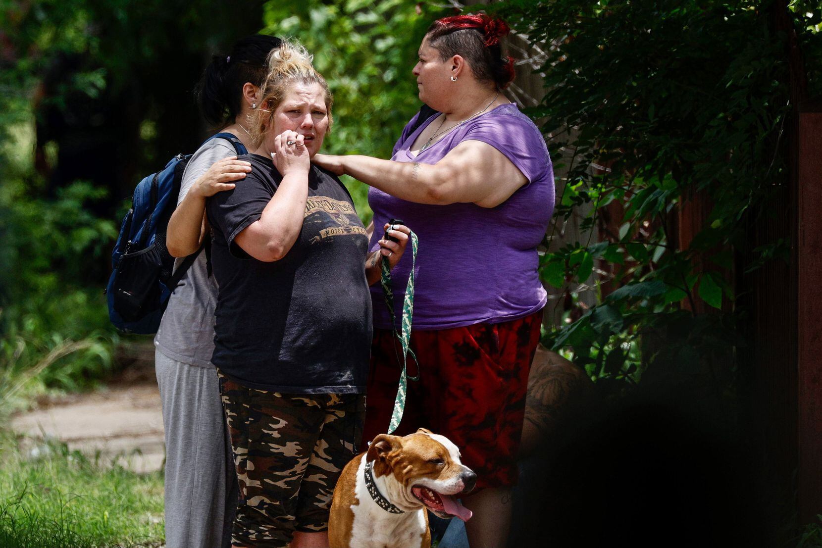 People gather near a police standoff with a murder and aggravated assault suspect who shot at police at near 51st Street and Humphrey Drive in south Dallas on Wednesday, June 2, 2021. 