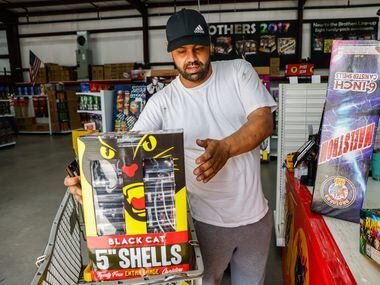 Orlando Ornelas, 39, checks out at the cash register at Nelson's Fireworks store in Rockwall...