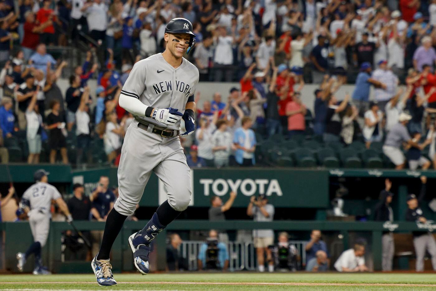 New York Yankees right fielder Aaron Judge (99) smiles as he rounds the bases after hitting...