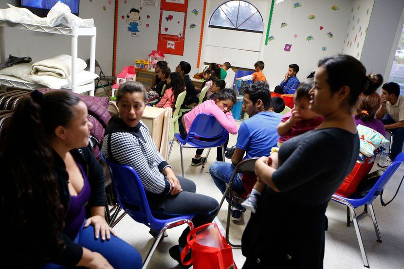 Children and parents wait at the Humanitarian Respite Center in McAllen, Texas, on June 10,...