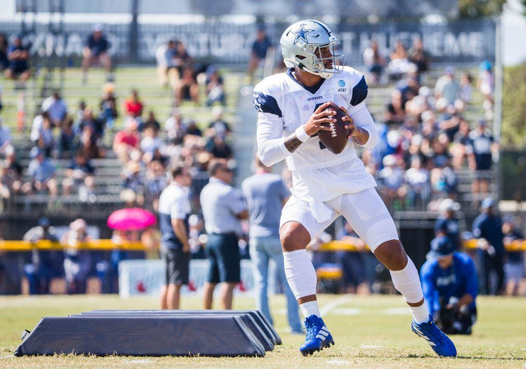 Dallas Cowboys quarterback Dak Prescott (4) runs a drill during an afternoon practice at...