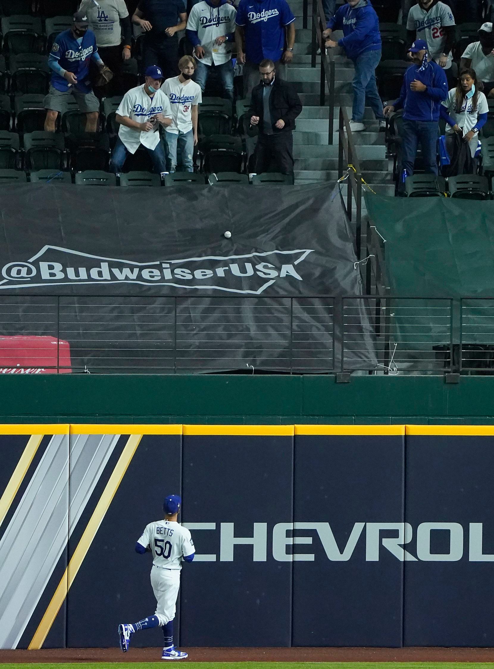 Los Angeles Dodgers right fielder Mookie Betts watches as a solo home run off the bat of...