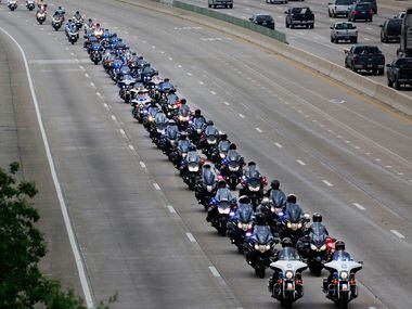 Dallas police officers lead the funeral procession for Dallas Police Officer Rogelio...