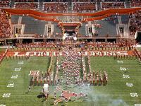 The Texas Longhorns football team races onto the newly named Campbell-Williams Field through the head of a longhorn at DKR-Texas Memorial Stadium, Saturday, September 4, 2021.