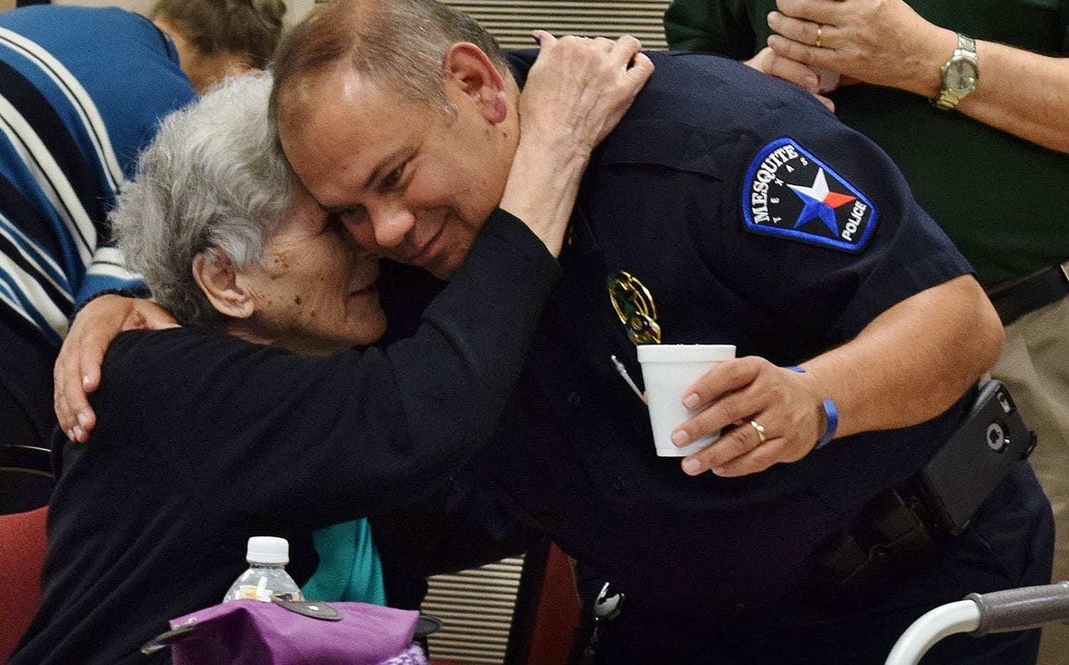 Police Chief Charles Cato gets a hug from a resident at a senior center in Mesquite.