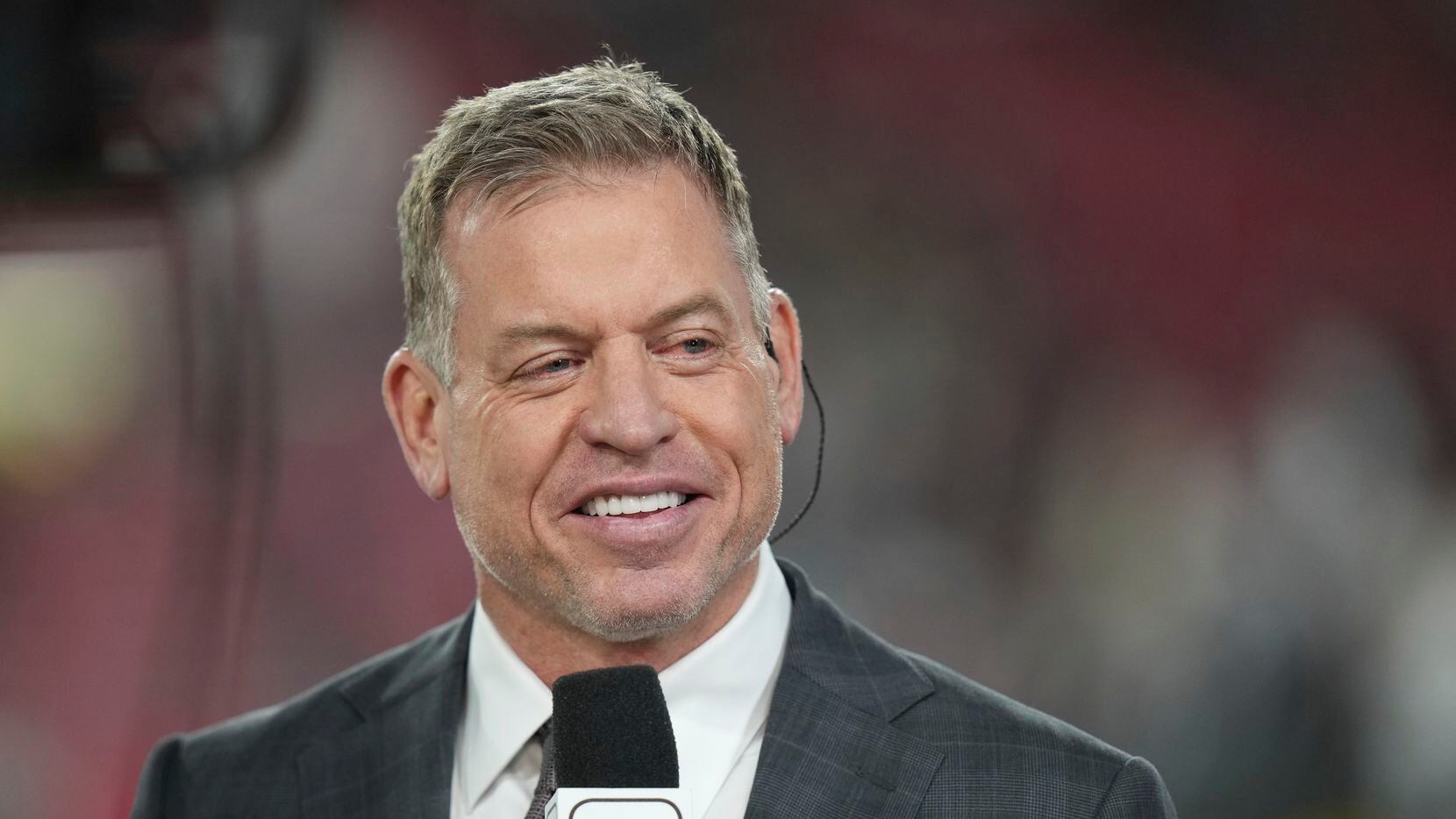 Former Dallas Cowboys quarterback Troy Aikman records a show on the sidelines before an NFL...