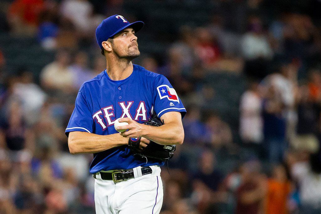 Texas Rangers starting pitcher Cole Hamels looks up at the scoreboard after a home by...