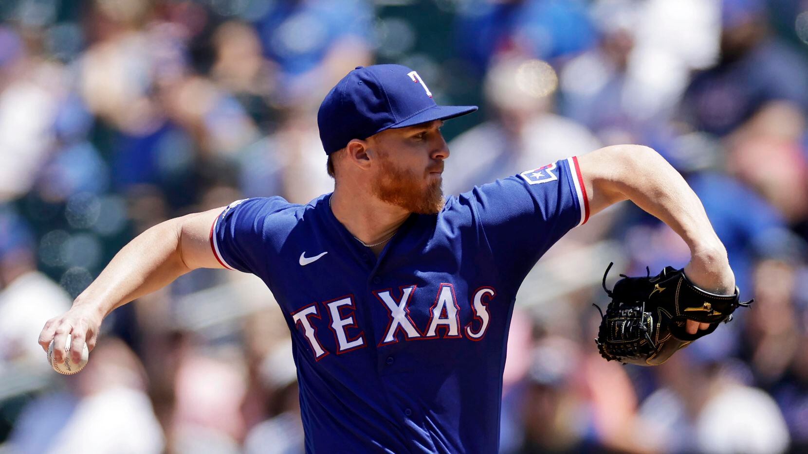 Texas Rangers pitcher Jon Gray throws during the first inning of a baseball game against the...