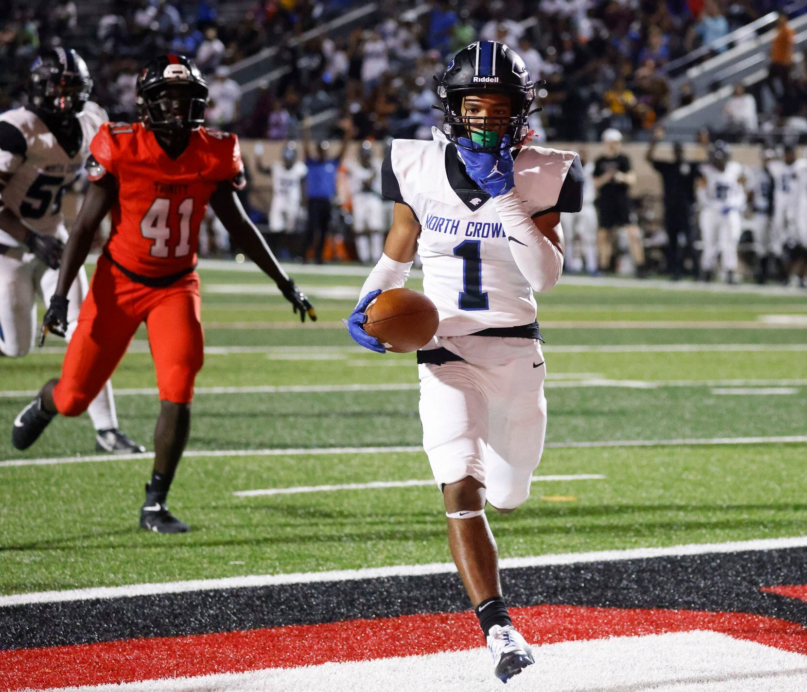 North Crowley’s Xavier Alexander (1) completes a touchdown against Trinity High during the...