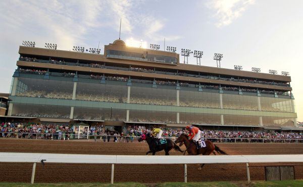 People watch a horse race from the grandstand at Lone Star Park.