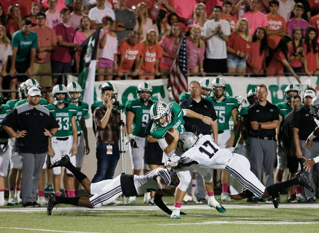 Denton Guyer senior defensive back Brent Jackson (29) and sophomore defensive back Jaden Fugett (17) tackle Southlake Carroll senior quarterback Will Bowers (14) during the first half of a high school football game at Dragon Stadium in Southlake, Friday, October 5, 2018. (Brandon Wade/Special Contributor)
