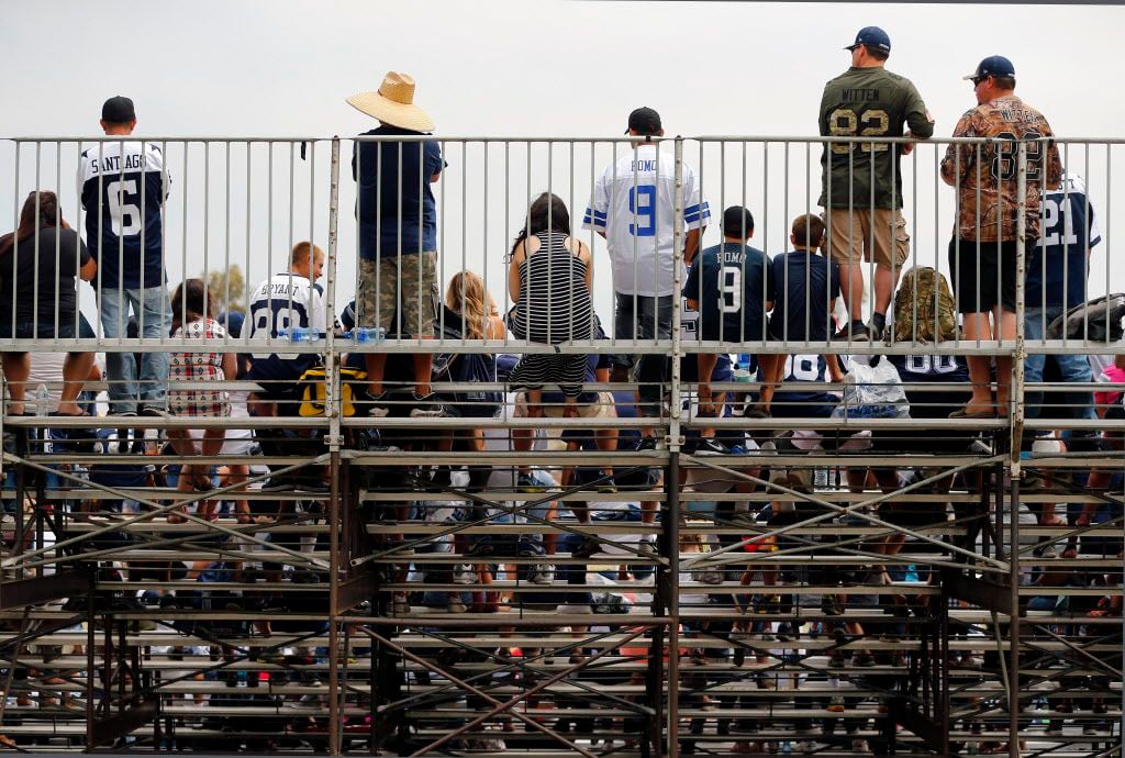 Dallas Cowboys fans watch the Blue-White Scrimmage fro the stands at training camp in...