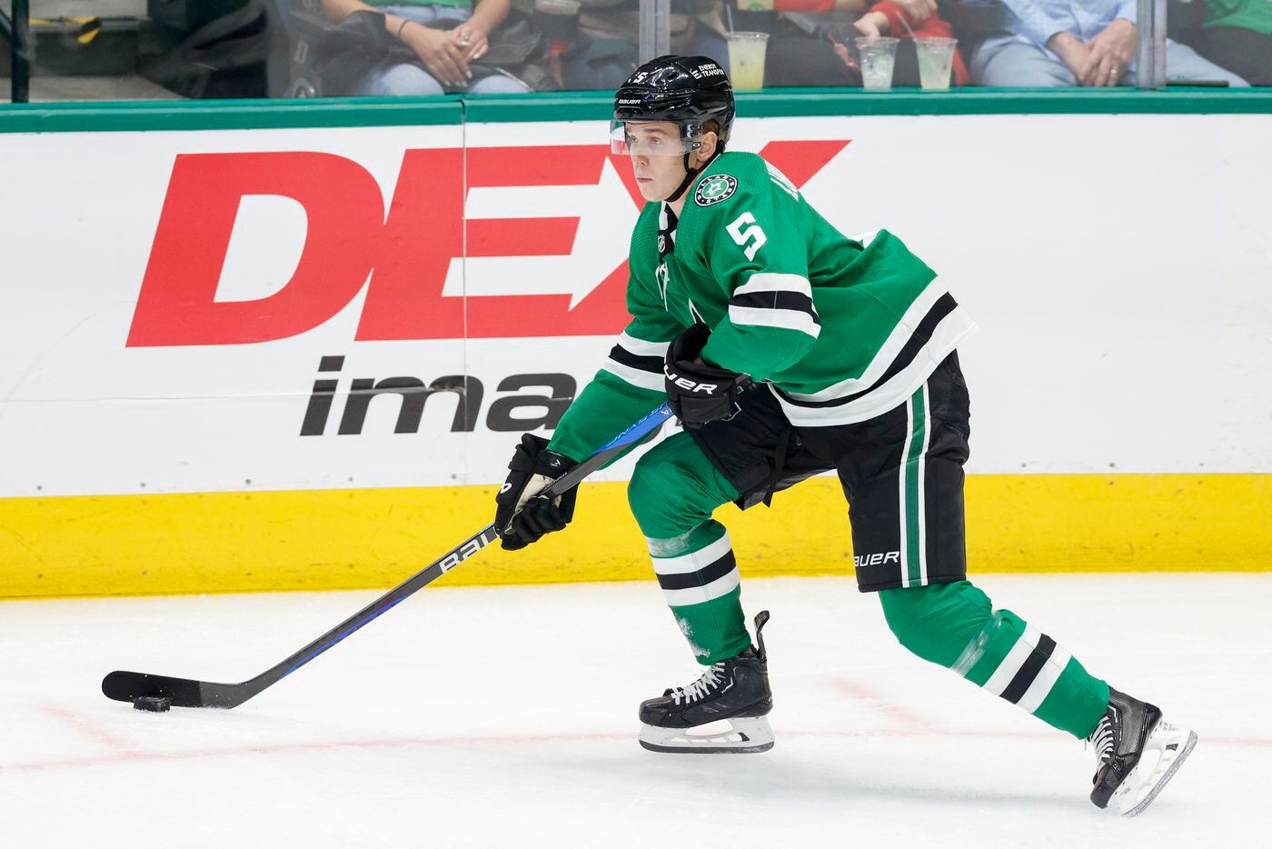 Dallas Stars defenseman Nils Lundkvist (5) pushes the puck up the ice during the first...