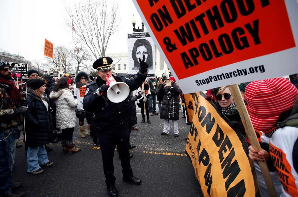 A U.S. Capitol Police officer warned abortion rights demonstrators to move as they attempted...