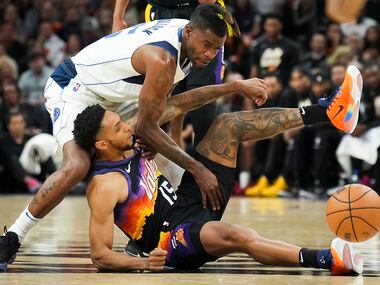 Phoenix Suns guard Cameron Payne (15) fights for a loose ball against Dallas Mavericks...