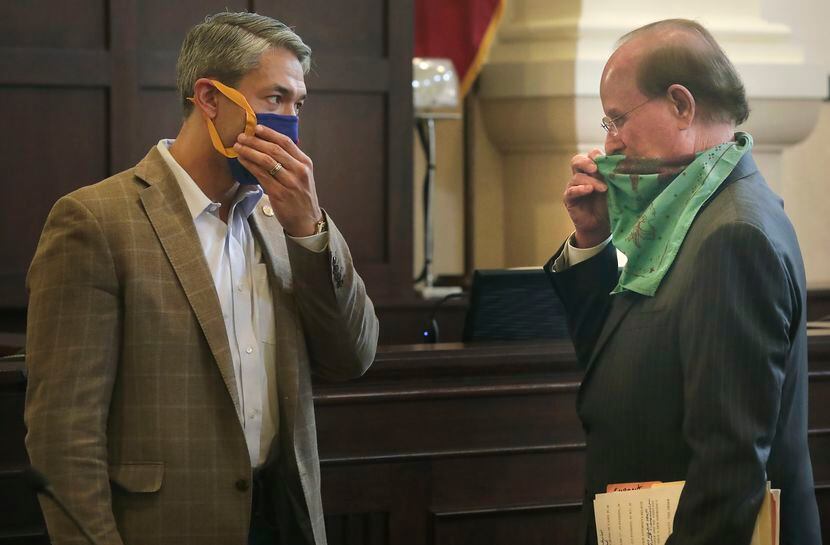 Bexar County Judge Nelson Wolff, right, and Mayor Ron Nirenberg, adjust their masks after a...