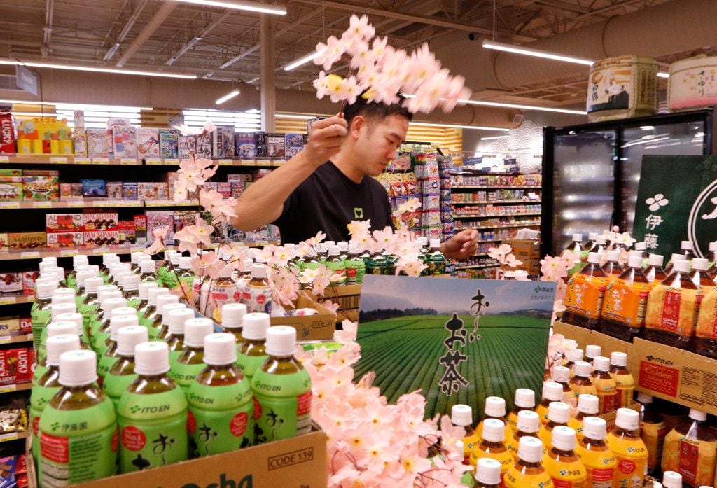 Masahio Noda, works on a unsweetened tea display at Mitsuwa Marketplace on Thursday, April...