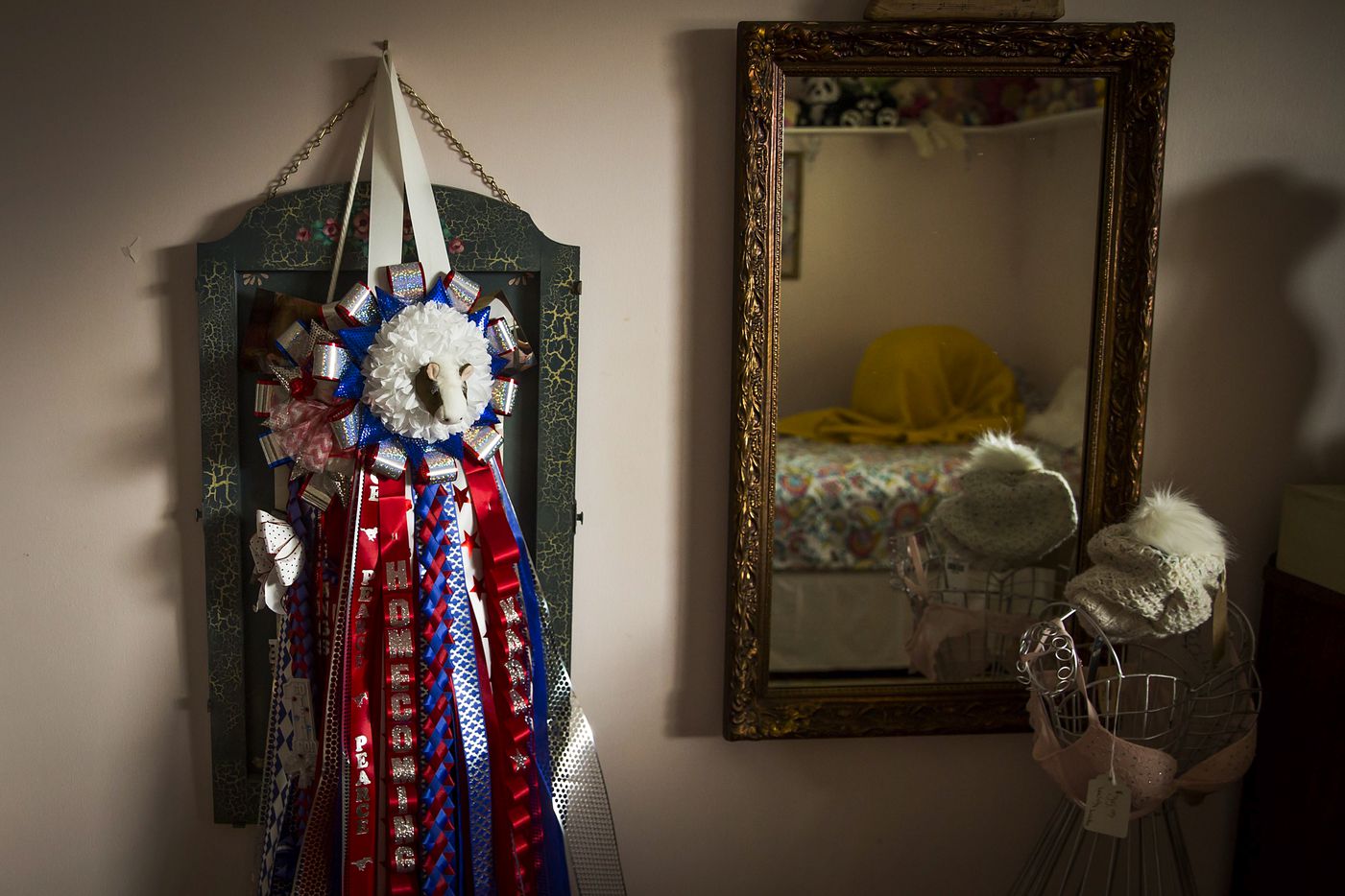 A homecoming mum presented to her by classmates at her school hangs on the wall as Kara...