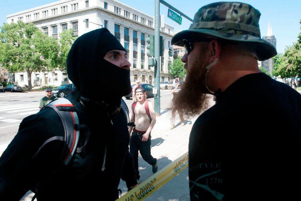 An Antifa demonstrator has a heated exchange with a pro-Trump supporter during the Denver...