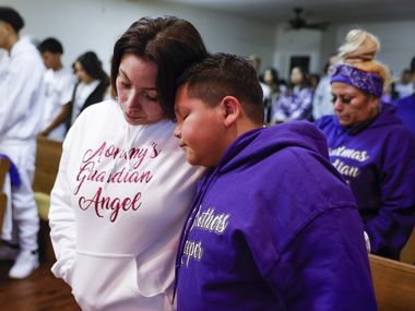 Mirtha Robles, mother of late Gabriel Zamora, 14, shares a moment with her other son Ayden...