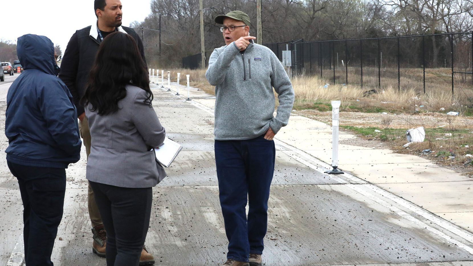Dallas resident Erich Schoenkopf (right) speaks with members of Dallas' public works and...