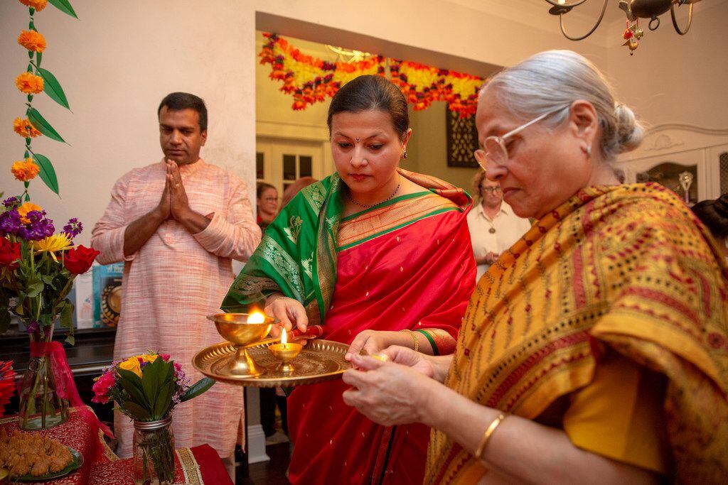 Sapna Punjabi-Gupta (center) joins her mother Saroj Punjabi and husband Saurabh Gupta in lighting a candle.
