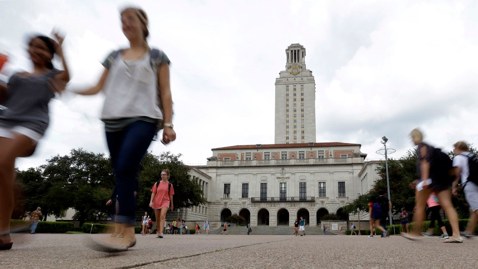 Students walk through the University of Texas at Austin campus near the school's iconic...
