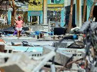 Ana Kapel walks through what is left of the Times Square area near the Lynn Hall Pier on the...