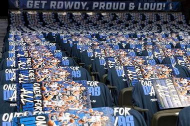 Dallas Mavericks posters and shirts cover seats at the American Airlines Center before Game...