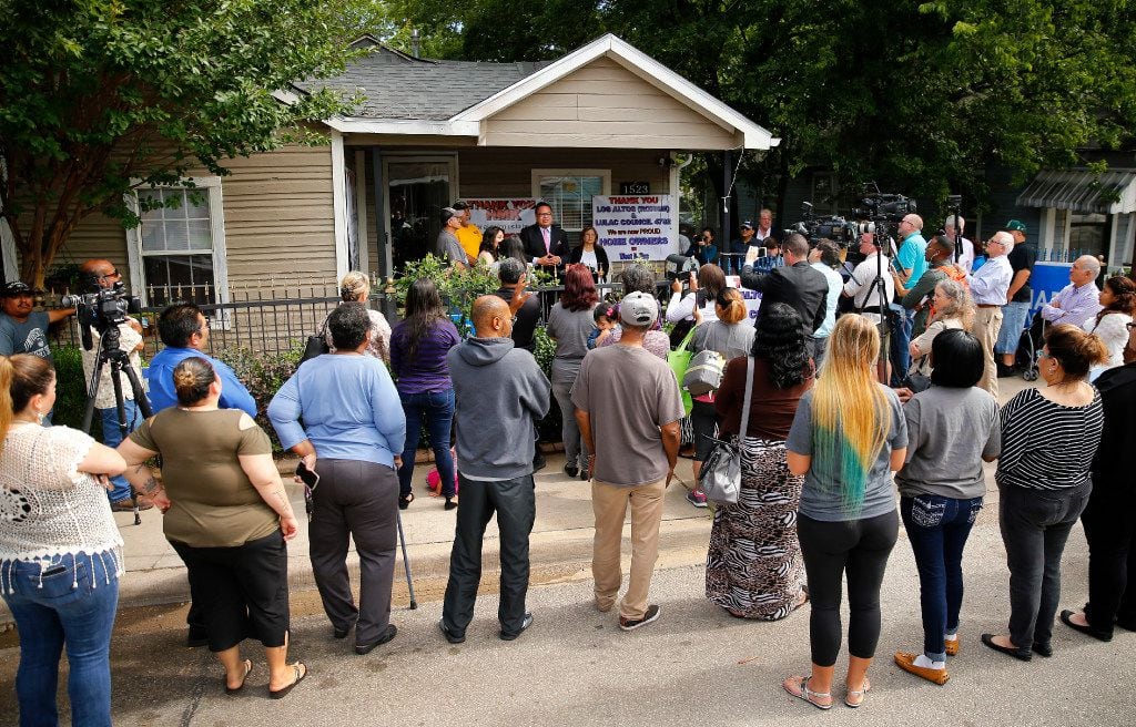 A crowd gathers in West Dallas to learn details of house sales by landlord HMK Ltd. as...