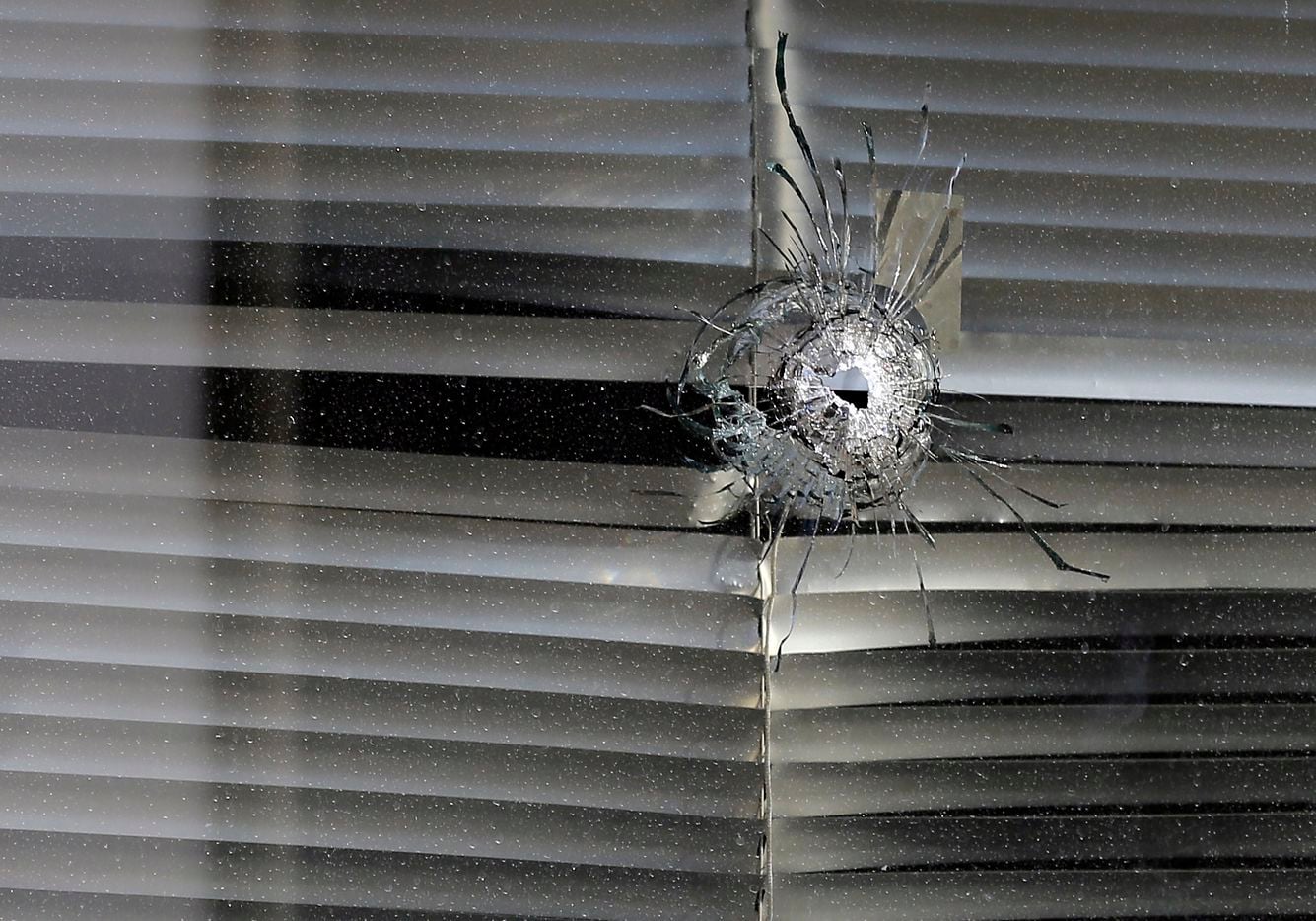 A bullet hole was seen in a window at El Centro College on July 14, 2016.