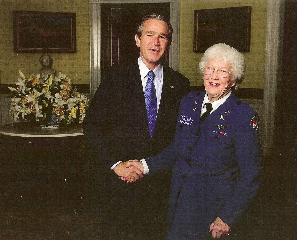 Elaine Harmon, left, shakes hands with President George W. Bush in 2007. Harmon was a member...
