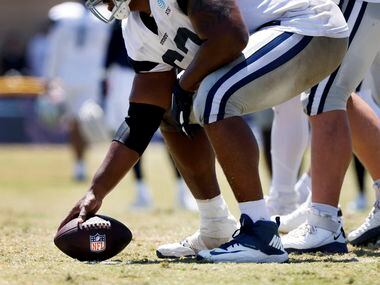 Dallas Cowboys center Tyler Biadasz (63) prepares to snap a NFL football during training...