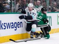 Seattle Kraken center Yanni Gourde (37) loses his stick as he and Dallas Stars' Ryan Suter...