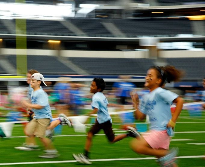 Irving Kids 'R Kids compete in the 50 yard dash at AT&T Stadium in Arlington. 