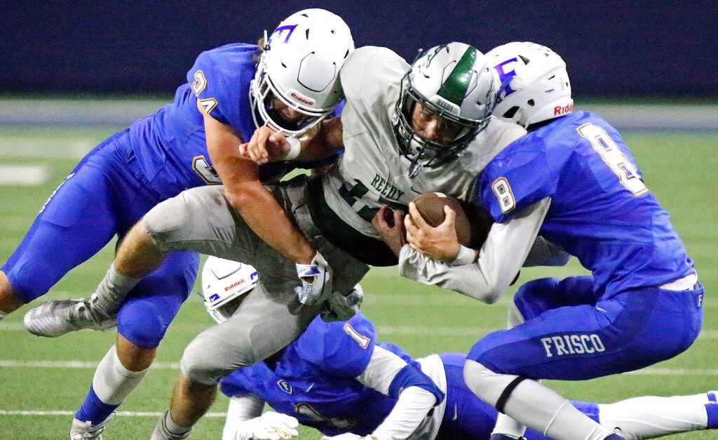 Reedy High School wide receiver Karston Farragut (17) is tackled by Frisco High School linebacker John Willis (34)  and Frisco High School defensive back Trent Bryant (8) during the first half as Reedy High School hosted Frisco High School in a district 7-5A football game at the Ford Center in Frisco on Friday, September 27, 2019. (Stewart F. House/Special Contributor)