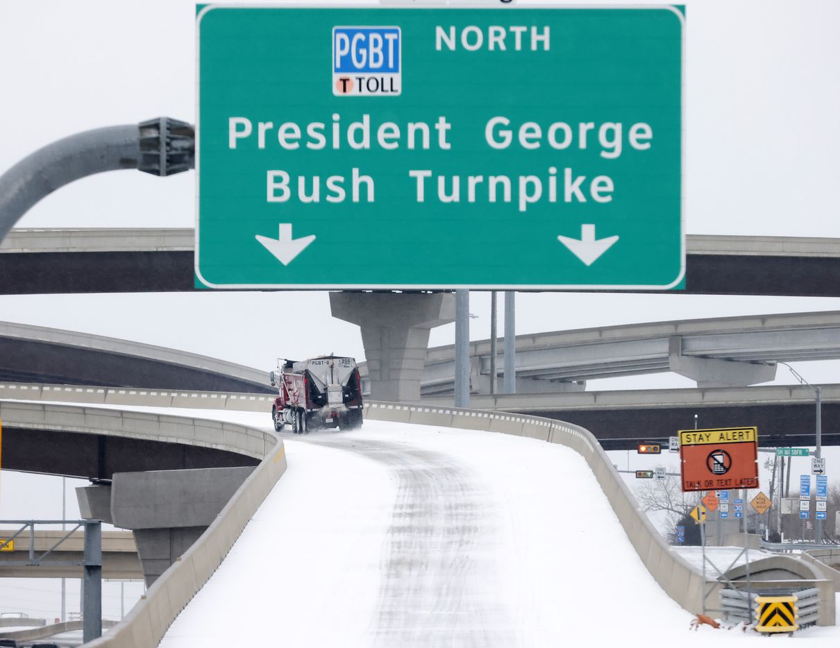 A truck spreads sand and gravel over an accumulation of sleet on a Bush Turnpike ramp from...