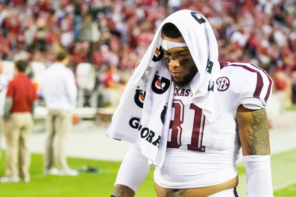 Texas A&M linebacker Claude George walks off the field after a loss to Alabama in an NCAA...