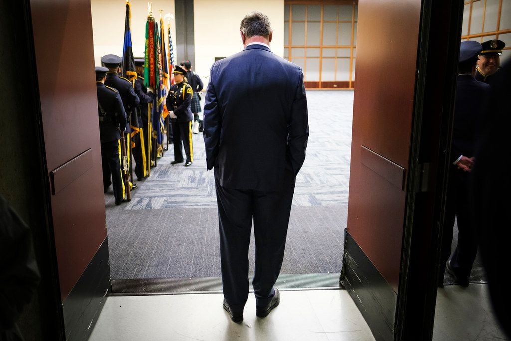 Dallas Mayor Mike Rawlings waits in a doorway for the Dallas Police memorial service,...