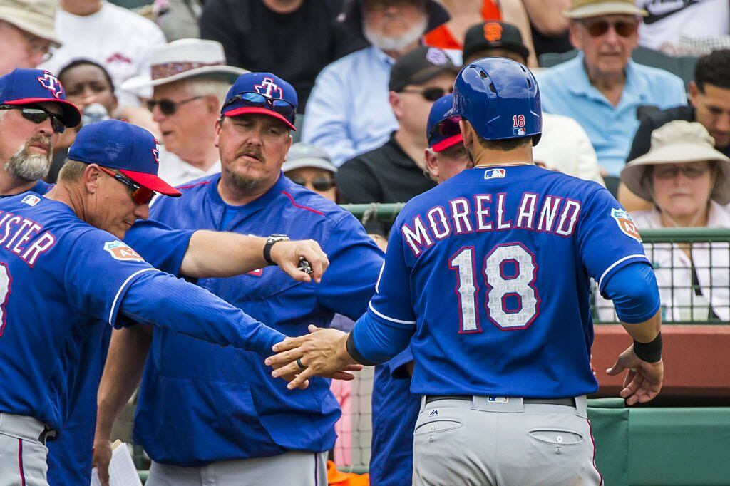 Texas Rangers first baseman Mitch Moreland gets a hand from manager Jeff Banister after...