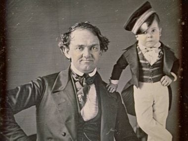 In this 1850 photograph, P.T. Barnum poses with his international star "General" Tom Thumb, his most popular attraction.