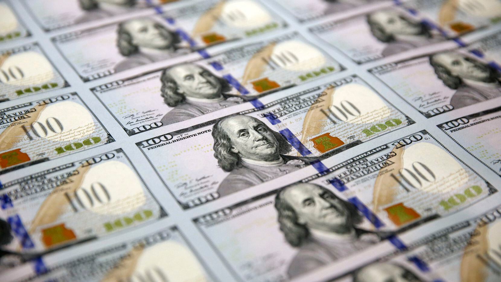 A sheet of uncut $100 bills makes the way through the printing process at the Bureau of...