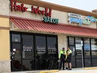 Police stand outside Hair World Salon in Dallas in May.