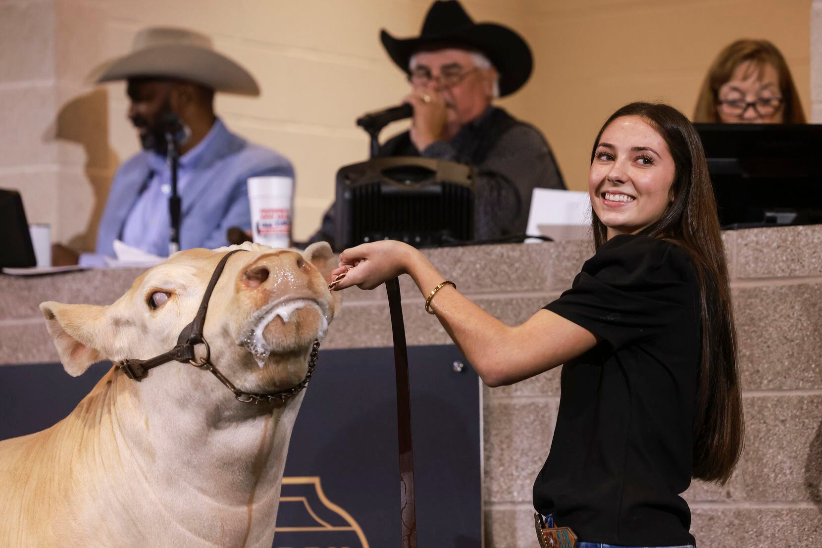 Aven Horn, 17, holds her steer, Blondie, during the Big Tex Youth Livestock Auction.