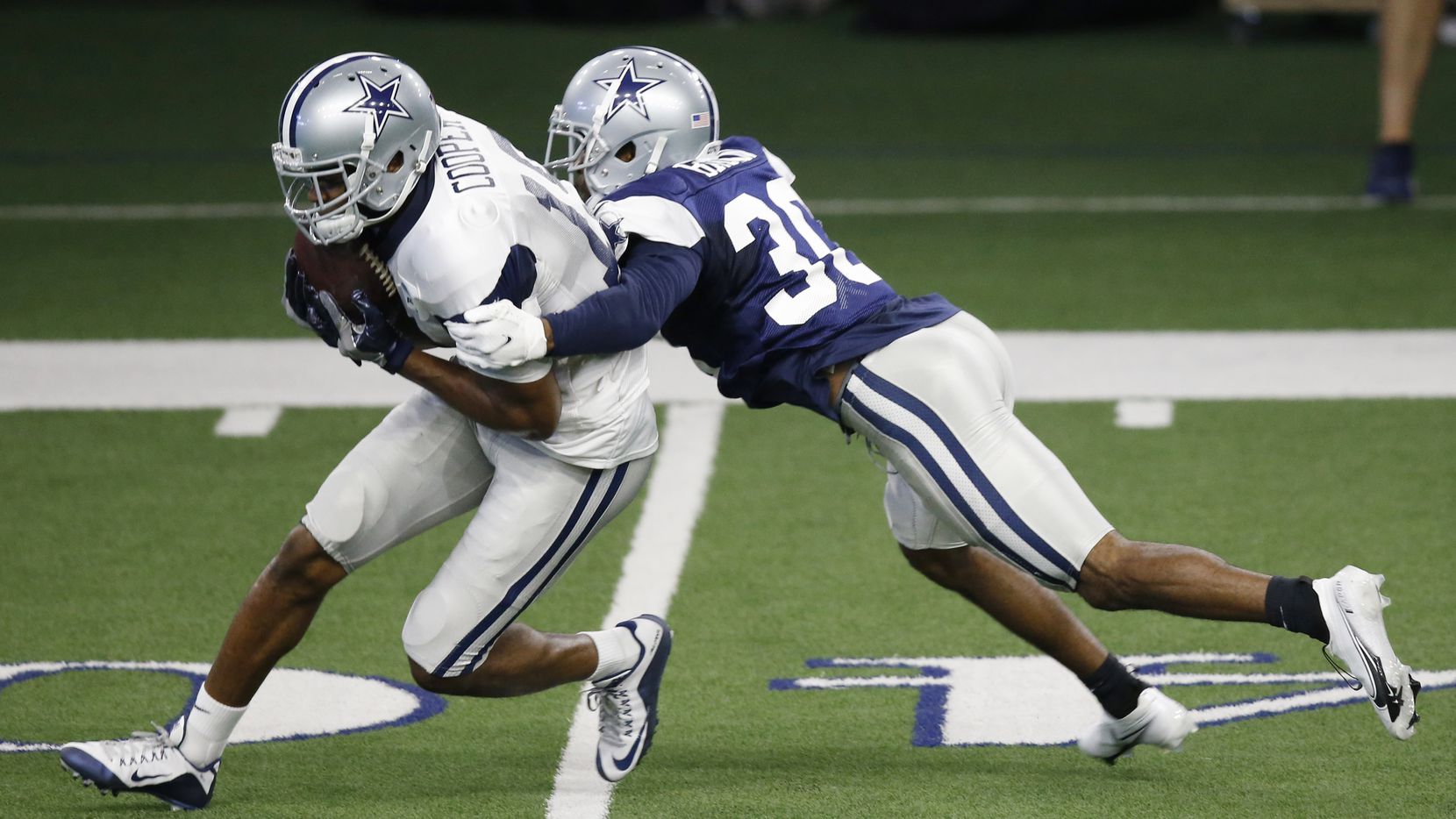 Dallas Cowboys wide receiver Amari Cooper (19) catches the ball in front of Dallas Cowboys...